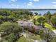 Aerial view of a home featuring solar panels, lush landscaping and a lake view at 208 Green Lake Cir, Longwood, FL 32779