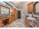 Well-lit bathroom featuring dual sinks, vanity, marble countertops, and a glass shower at 208 Green Lake Cir, Longwood, FL 32779