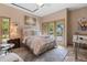 Cozy bedroom featuring neutral tones, stone floors, and french doors leading to outdoor views at 208 Green Lake Cir, Longwood, FL 32779