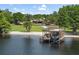 View of the boathouse at the water's edge featuring a covered boat lift, seating area, and ladder at 208 Green Lake Cir, Longwood, FL 32779