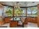 Gourmet kitchen boasts granite countertops, dual islands, breakfast bar, and large windows with lush views at 208 Green Lake Cir, Longwood, FL 32779