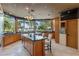 Spacious kitchen featuring granite countertops, an island with seating, stainless appliances, and gorgeous lake views at 208 Green Lake Cir, Longwood, FL 32779