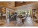 Sun-filled living and dining area boasts stone floors, a fireplace, and gorgeous views of the surrounding landscape at 208 Green Lake Cir, Longwood, FL 32779