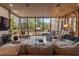 Bright living room featuring floor-to-ceiling windows overlooking a lush garden and comfortable seating at 208 Green Lake Cir, Longwood, FL 32779