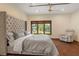 Bright bedroom featuring a large bed, comfortable seating, and beautiful views of the outdoors at 208 Green Lake Cir, Longwood, FL 32779