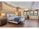 Comfortable bedroom features a king bed, wood floors, and large windows at 208 Green Lake Cir, Longwood, FL 32779