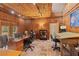 Wood-paneled office with natural lighting, multiple work stations, and stone tile flooring at 208 Green Lake Cir, Longwood, FL 32779