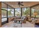 Relaxing sunroom with outdoor view, comfortable seating, and access to the pool area at 208 Green Lake Cir, Longwood, FL 32779