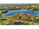 Aerial view shows a house on a large lot near a lake at 39250 Forest Dr, Eustis, FL 32736