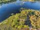 Aerial view of house on waterfront property with lush green landscape at 39250 Forest Dr, Eustis, FL 32736