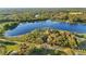 Aerial view of house on a waterfront lot with mature trees at 39250 Forest Dr, Eustis, FL 32736