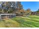 Play area with chicken coop and playground set in grassy backyard at 39250 Forest Dr, Eustis, FL 32736