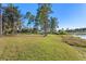 Spacious backyard with a lake view and lush greenery at 39250 Forest Dr, Eustis, FL 32736