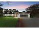 House exterior at dusk with a two-car garage at 39250 Forest Dr, Eustis, FL 32736