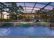 Lighted pool and spa at dusk with waterfalls at 39250 Forest Dr, Eustis, FL 32736