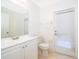 Clean bathroom with white vanity, toilet and exterior access at 608 Abaco Ct, Kissimmee, FL 34746