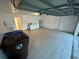 Large garage featuring laundry facilities and a service door at 608 Abaco Ct, Kissimmee, FL 34746