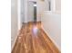 Long hallway with wood-look flooring leading to bedrooms and bath at 608 Abaco Ct, Kissimmee, FL 34746