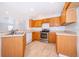 Bright kitchen featuring wood cabinets, stainless steel appliances and wood-look tile flooring at 608 Abaco Ct, Kissimmee, FL 34746