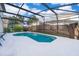 Sparkling screened-in pool with a white concrete deck, perfect for outdoor relaxation at 608 Abaco Ct, Kissimmee, FL 34746