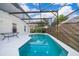 Sparkling screened-in pool with a white concrete deck, perfect for outdoor relaxation at 608 Abaco Ct, Kissimmee, FL 34746