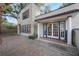 Charming two-story home featuring stucco walls, blue trim, red shutters, and a brick paved driveway at 2019 S Park Ave, Sanford, FL 32771