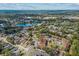 An aerial view of a residential area near a tranquil lake, showcasing the community's serene environment at 4945 Sanoma Vlg # B, Orlando, FL 32808