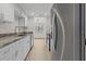 Updated kitchen featuring stainless steel appliances, stone countertops and white cabinets at 4945 Sanoma Vlg # B, Orlando, FL 32808