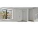 Bright living room with a large window, a front door and a staircase at 4945 Sanoma Vlg # B, Orlando, FL 32808