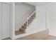 A staircase leads to the upper level, featuring light-colored wood steps and white railings at 4945 Sanoma Vlg # B, Orlando, FL 32808