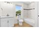 Clean bathroom with white vanity, bathtub, and light wood-look floors at 1929 Sipes Ave, Sanford, FL 32771