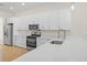 Modern kitchen with white cabinets, stainless steel appliances, and quartz countertops at 1929 Sipes Ave, Sanford, FL 32771