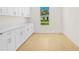 Laundry room with white cabinets and light hardwood floors at 1929 Sipes Ave, Sanford, FL 32771