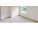 Bright bedroom with ample closet space and carpeted floor at 1112 Camden Way, Poinciana, FL 34758