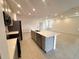 Modern kitchen with gray cabinets, quartz countertops, and stainless steel appliances at 1112 Camden Way, Poinciana, FL 34758