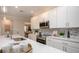 Bright kitchen with white cabinets, stainless steel appliances, and quartz countertops at 204 Barrington Dr, Haines City, FL 33844