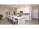 Modern kitchen with white cabinets, quartz countertops, and a large island at 204 Barrington Dr, Haines City, FL 33844