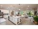 Open concept kitchen with white cabinets, island with seating, and living room view at 204 Barrington Dr, Haines City, FL 33844