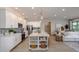 Modern kitchen with white cabinets, large island, and open layout to living area at 204 Barrington Dr, Haines City, FL 33844