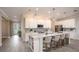 Open concept kitchen features white cabinets and island, stainless steel appliances at 204 Barrington Dr, Haines City, FL 33844