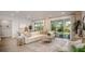 Relaxing living room with light-colored sofa, large windows, and ample natural light at 204 Barrington Dr, Haines City, FL 33844