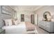 Bright main bedroom with neutral tones, a large bed, and ample closet space at 204 Barrington Dr, Haines City, FL 33844