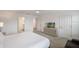 This bedroom has a tv, dresser and closet. There is a view into the bathroom as well at 8951 Hilton Ridge Ave, Kissimmee, FL 34747