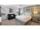 This bedroom has a decorative wall, and contains a queen bed, couch, and side tables at 8951 Hilton Ridge Ave, Kissimmee, FL 34747