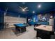 This game room has epoxy floors, a pool table, foosball table, and air hockey at 8951 Hilton Ridge Ave, Kissimmee, FL 34747
