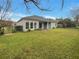Back of home featuring a screened-in porch, well-maintained lawn, and privacy fencing at 148 Blue Stone Cir, Winter Garden, FL 34787
