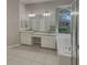 Bathroom featuring dual sinks, granite countertops, large mirrors, and a garden tub at 148 Blue Stone Cir, Winter Garden, FL 34787