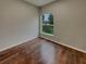 Empty bedroom with hardwood floors, a window view to the backyard, and light gray walls at 148 Blue Stone Cir, Winter Garden, FL 34787