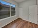 Bedroom with wood floors, natural light from a window, and a closet at 148 Blue Stone Cir, Winter Garden, FL 34787