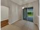 Dining area with hardwood floors, sliding glass door and modern light fixture at 148 Blue Stone Cir, Winter Garden, FL 34787